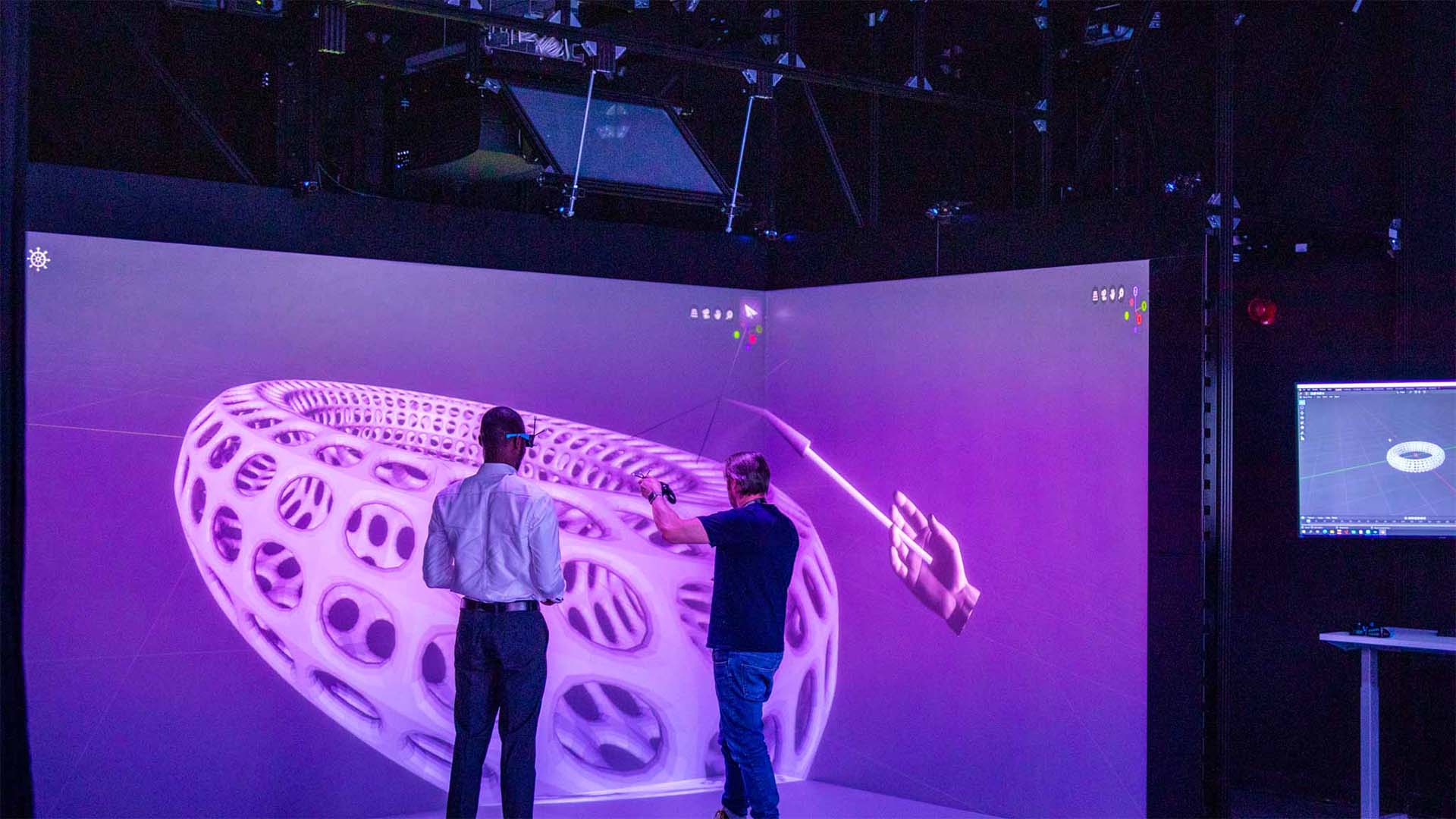 Students using visualisation facilities to see a 3D model on the wall