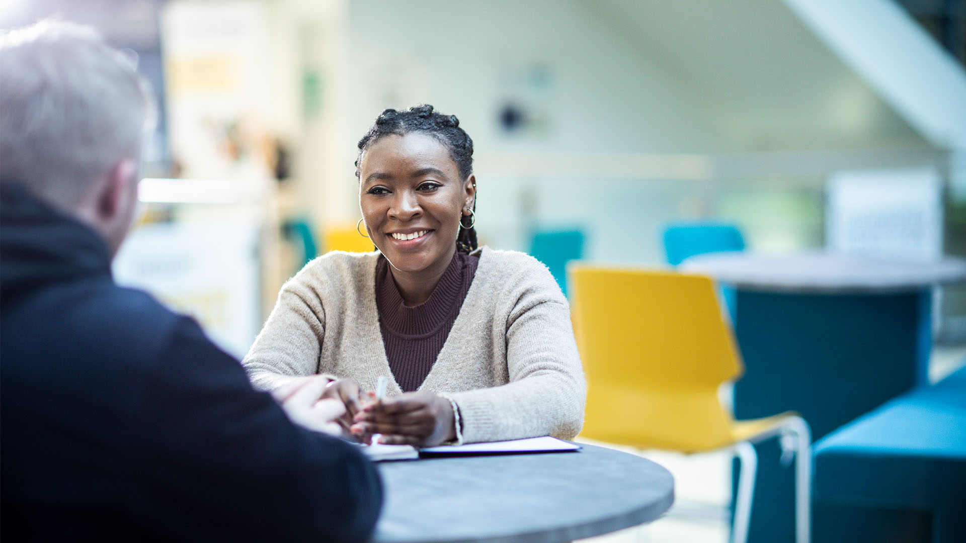 Students speaking across a table