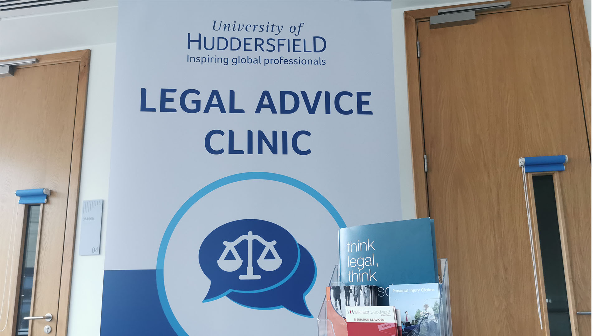 Sign saying Legal Advice Clinic infront of a table with leafets on it