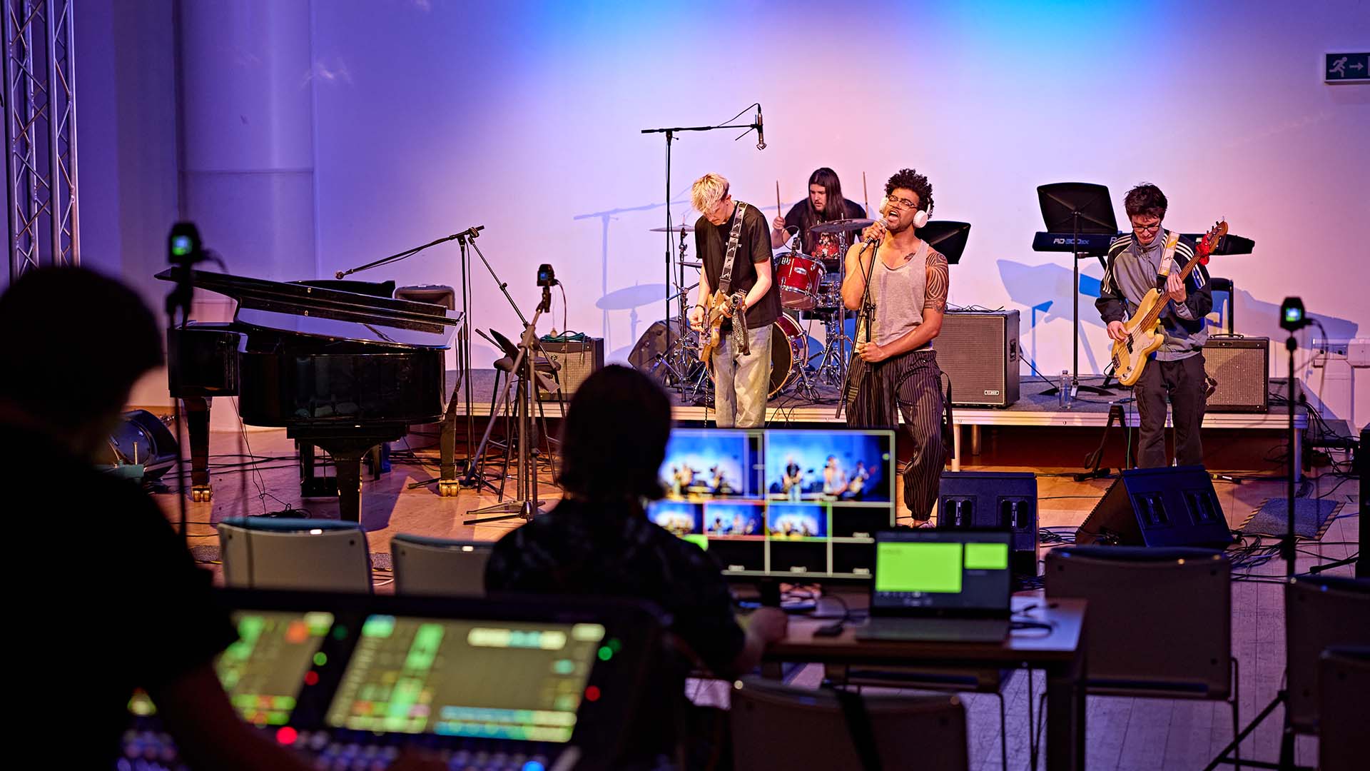 Students practicing in a band on stage