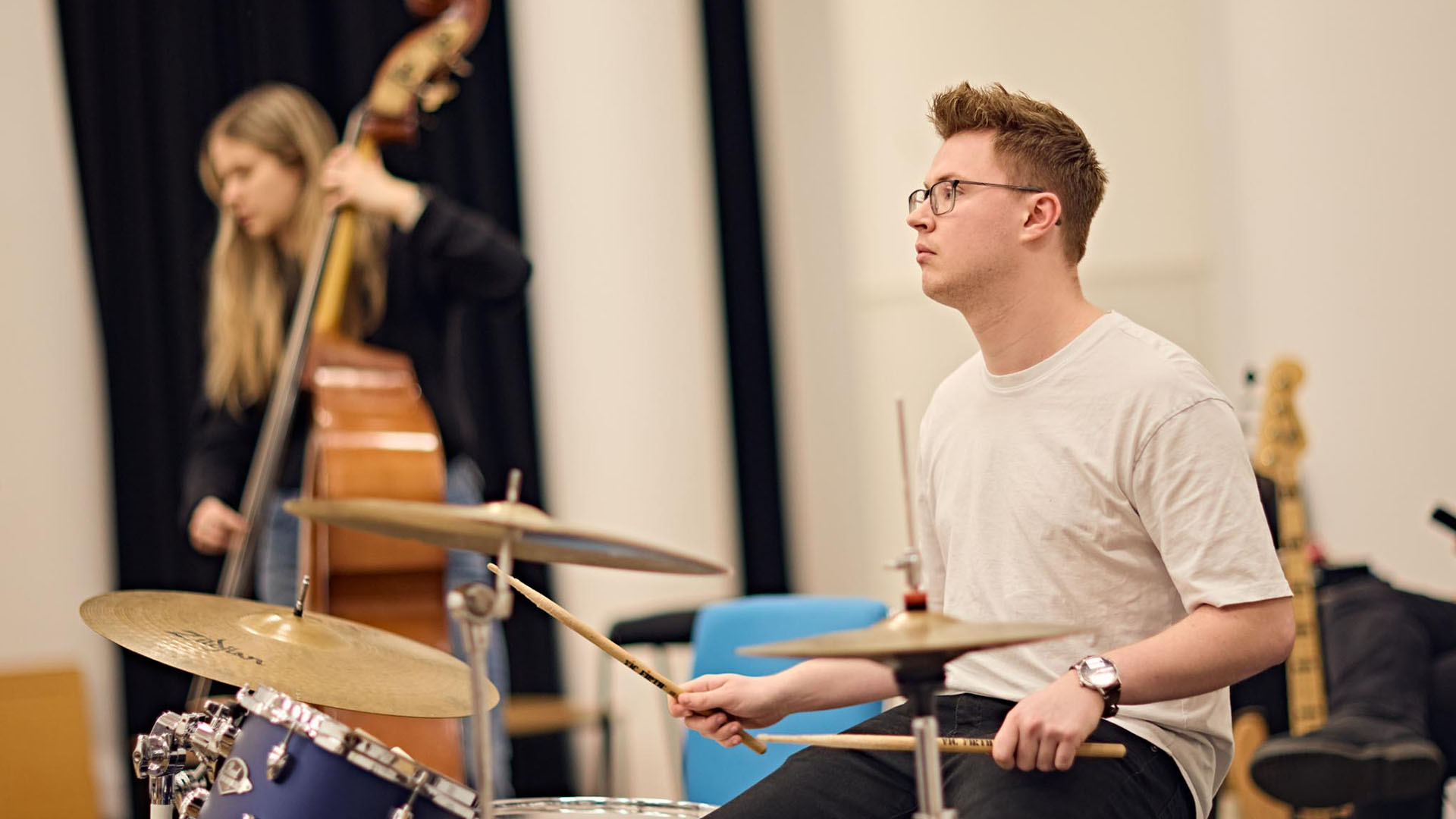 Student practicing playing the drums