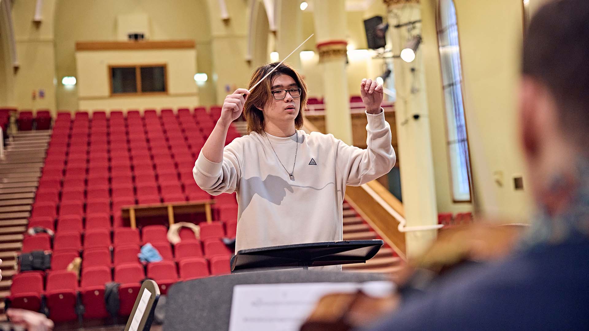Music student conducting at St Paul's Hall