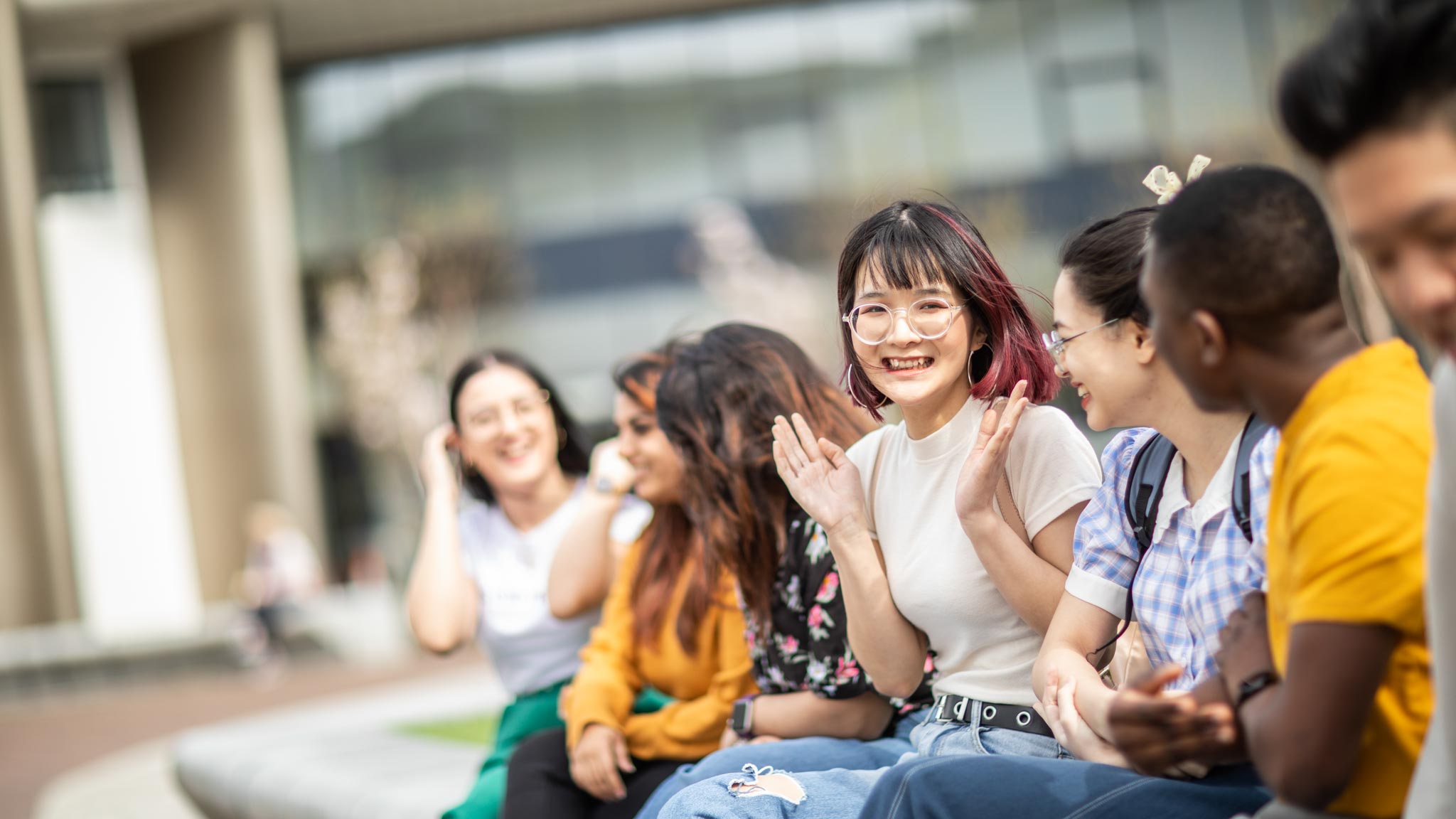 Students laughing at Huddersfield campus