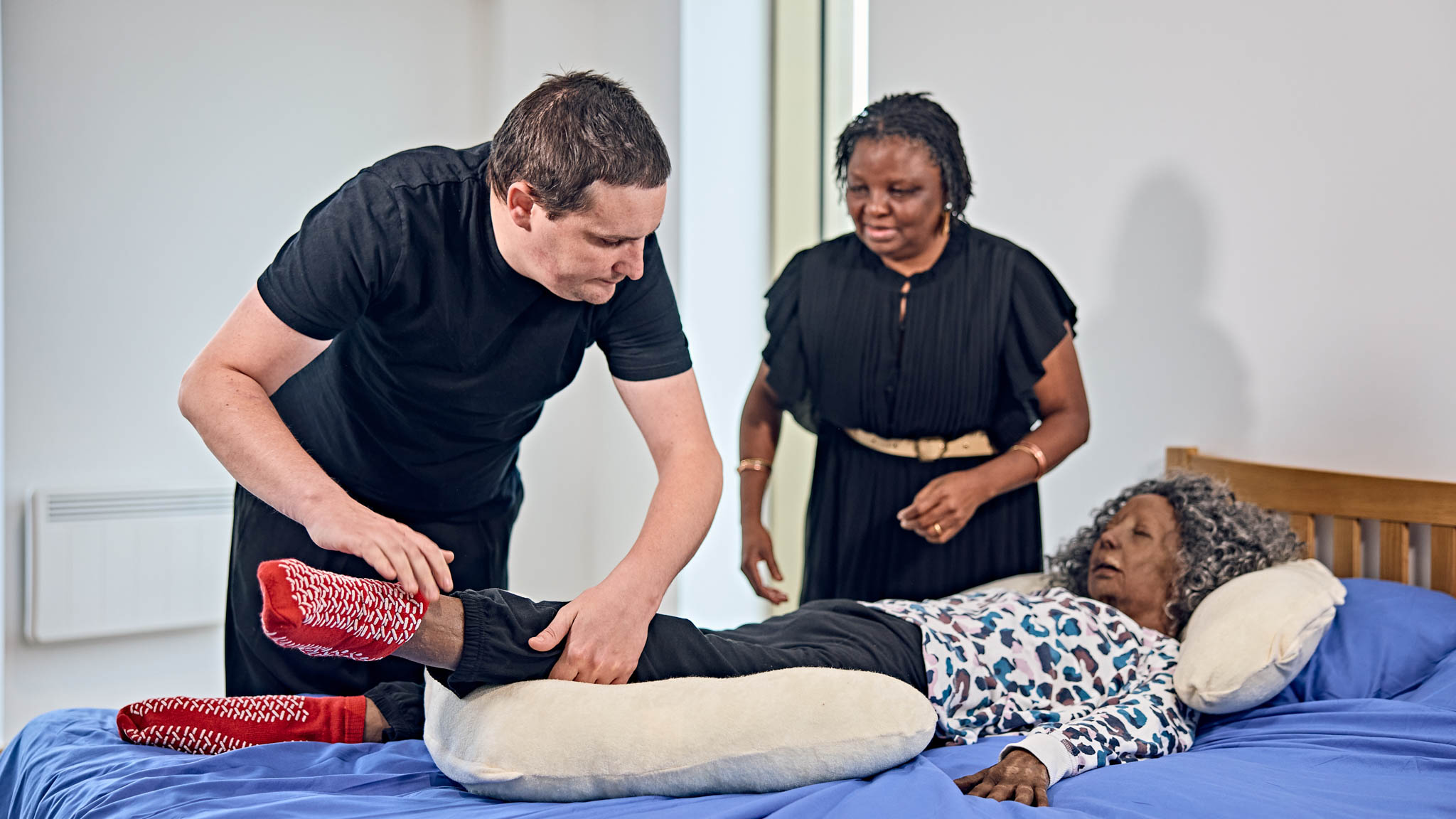 Students caring for patients in simulated home environment.