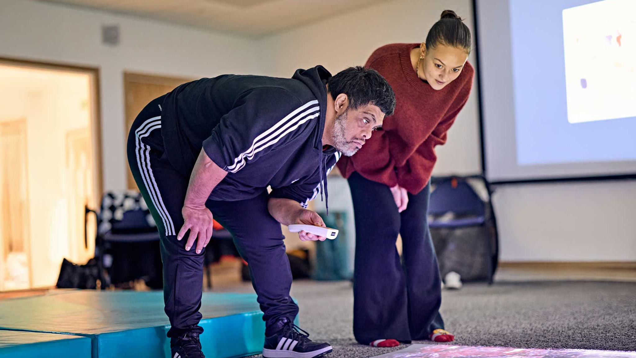 student and service user explore choice using the interactive floor projection