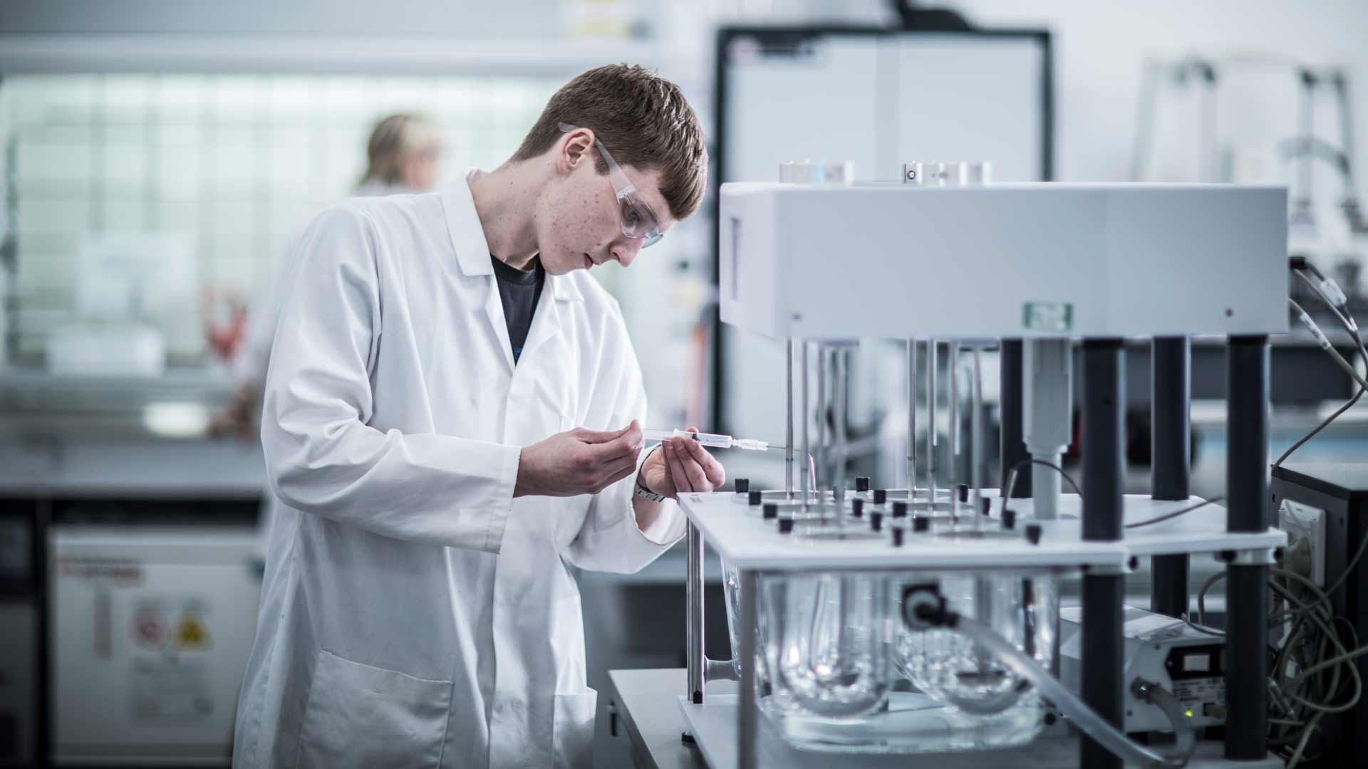 Pharmacy student practicing laboratory techniques