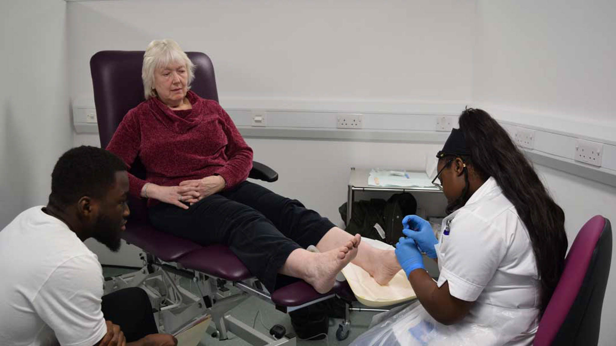 Collaborative learning in action—podiatry and pharmacy students working together to support patient care.